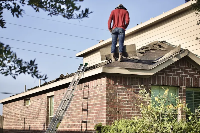 Professional roofer working on a residential roof in Barnitz